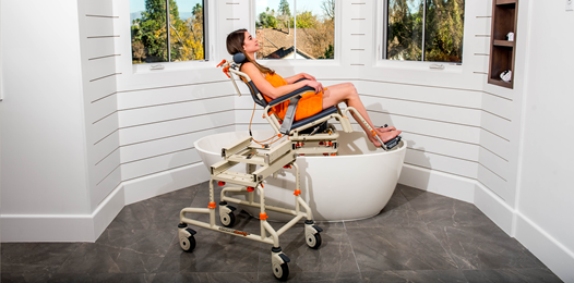 Woman using bath lift to get into bath tub